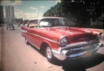 Chevy with a horse and cart in the background