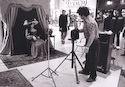 Unidentified photographer using flash and a dark background